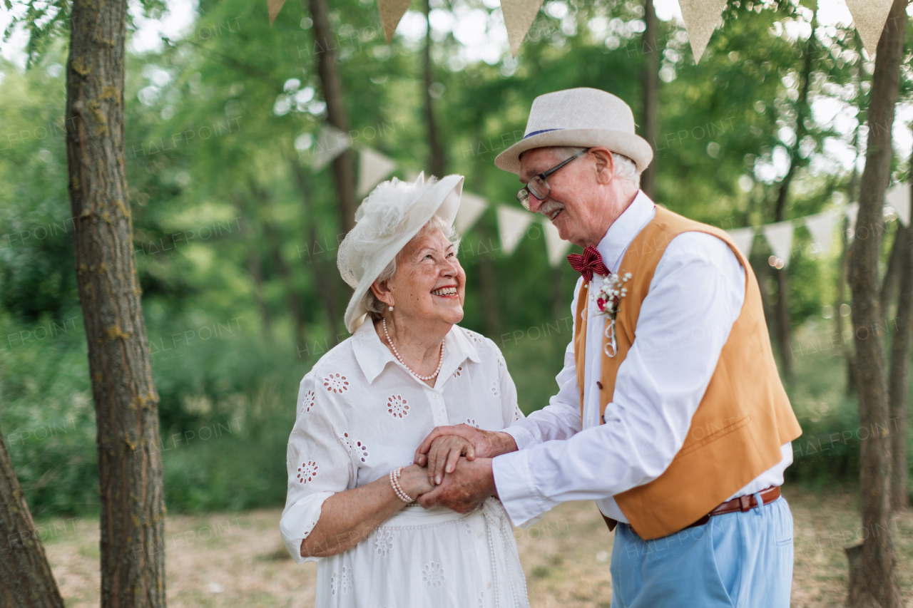 Senior couple having marriage in nature during a summer day.