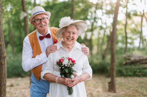 Senior couple having marriage in nature during a summer day.