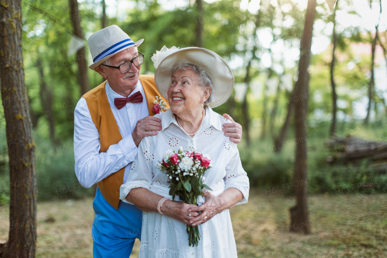 Senior couple having marriage in nature during a summer day.