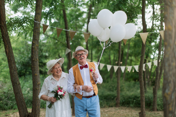 Senior couple having marriage in nature during a summer day.