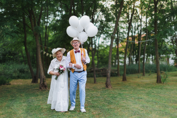 Senior couple having marriage in nature during a summer day.