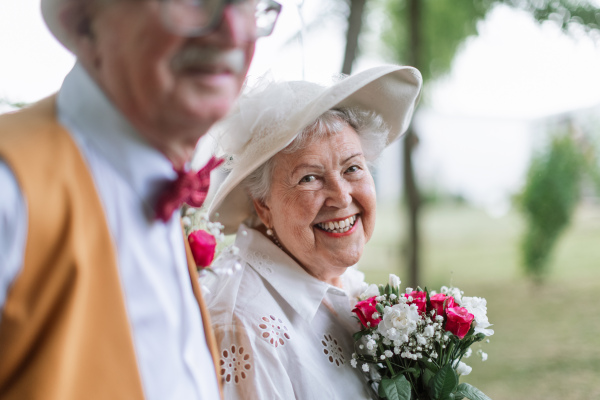 Senior couple having marriage in nature during a summer day. Portrait of bride.