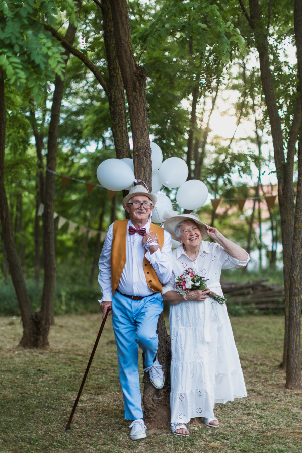 Senior couple having marriage in nature during a summer day.