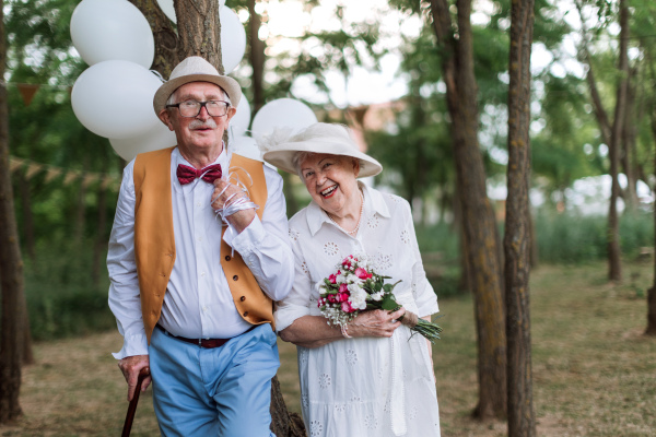 Senior couple having marriage in nature during a summer day.