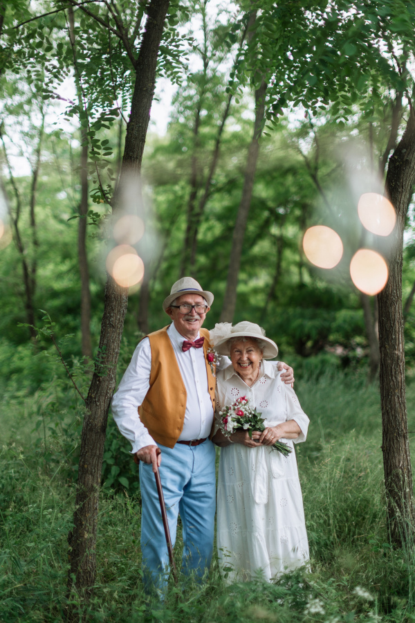 Senior couple having marriage in nature during a summer day.