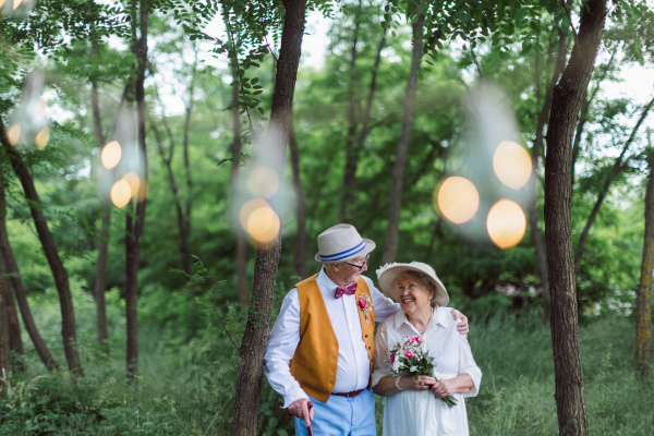 Senior couple having marriage in nature during a summer day.