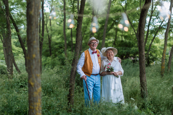 Senior couple having marriage in nature during a summer day.