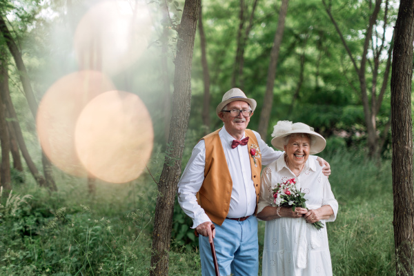 Senior couple having marriage in nature during a summer day.