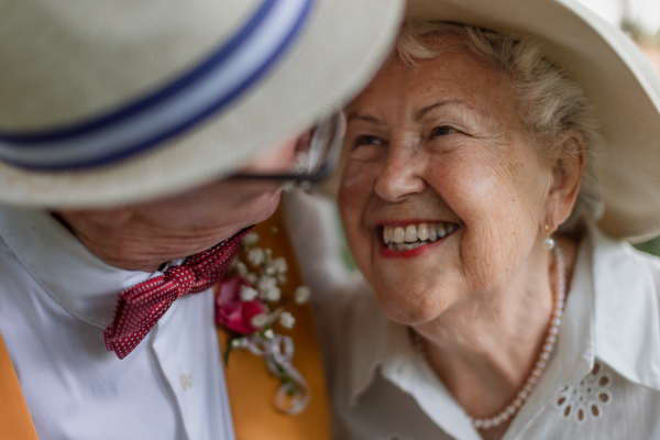 Portrait of senior couple having marriage in nature during the summer day.