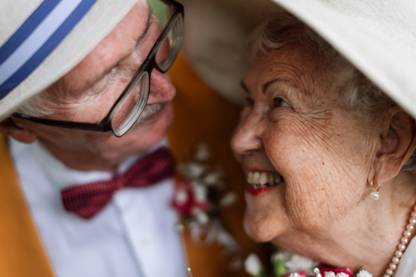 Portrait of senior couple having marriage in nature during the summer day.