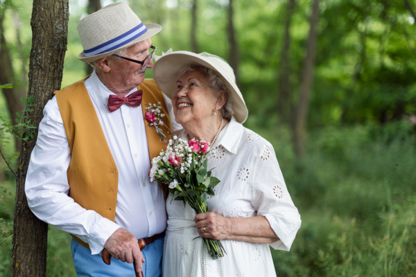 Senior couple having marriage in nature during a summer day.