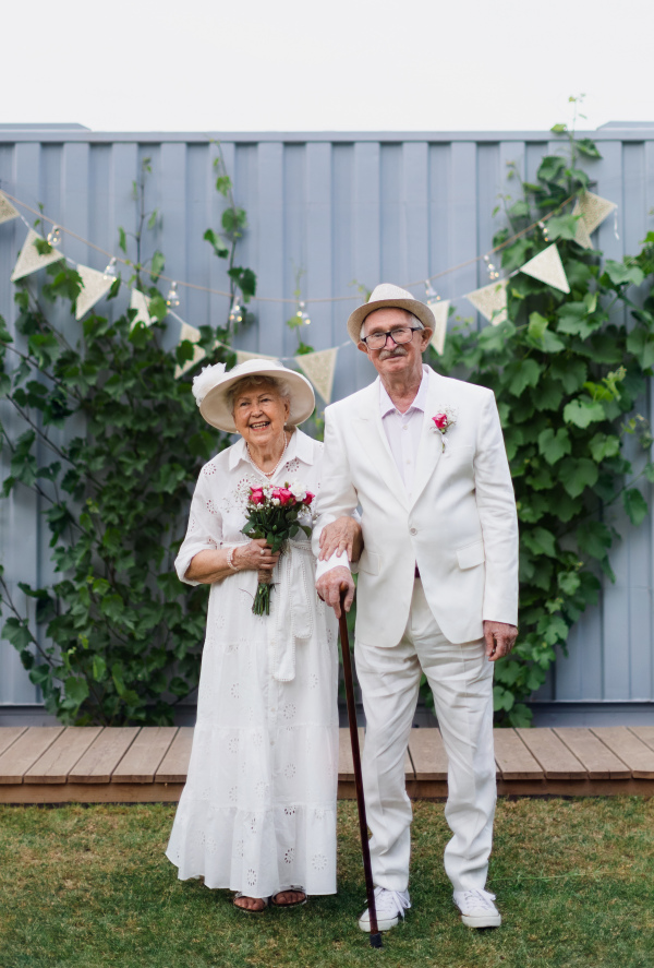 Senior couple having marriage in garden during a summer day.