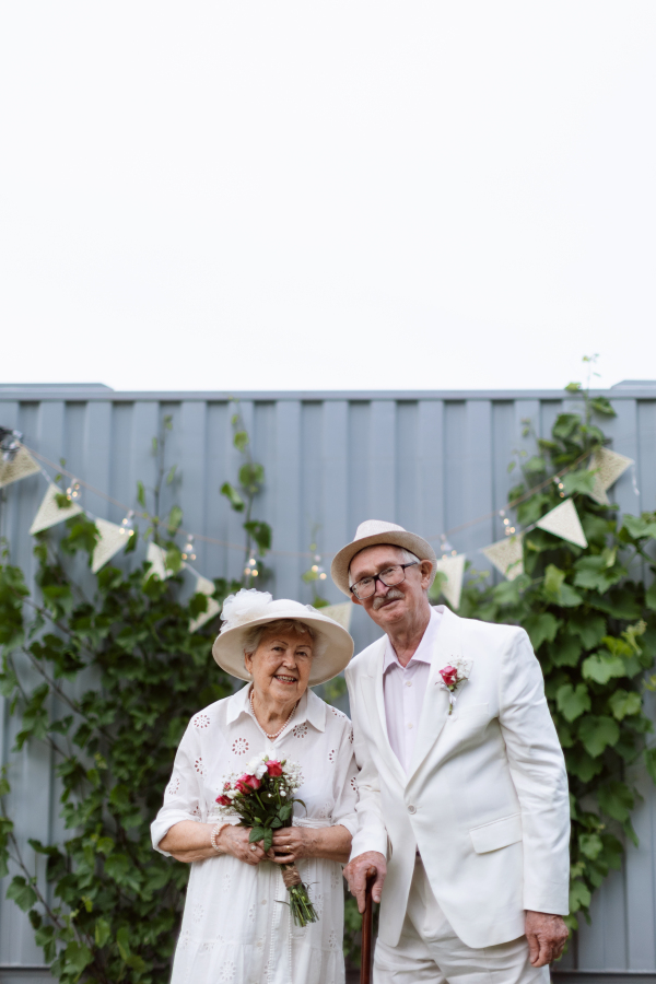 Senior couple having marriage in garden during a summer day.