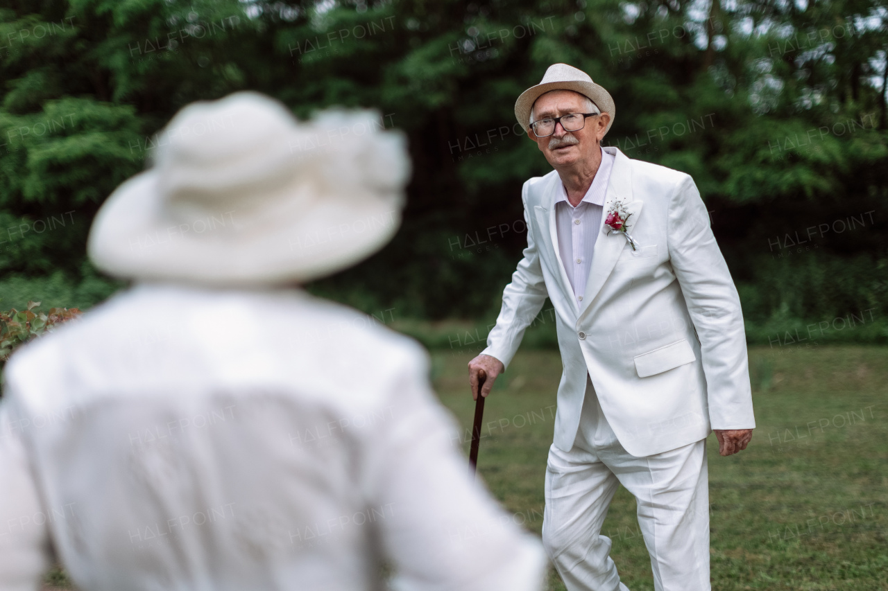 Senior couple having marriage in nature during a summer day.