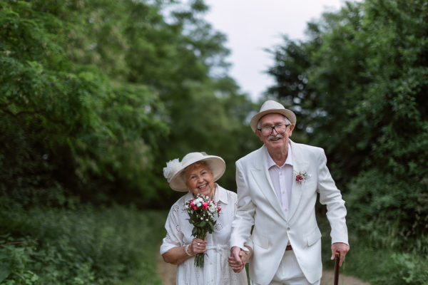 Senior couple having marriage in nature during a summer day.