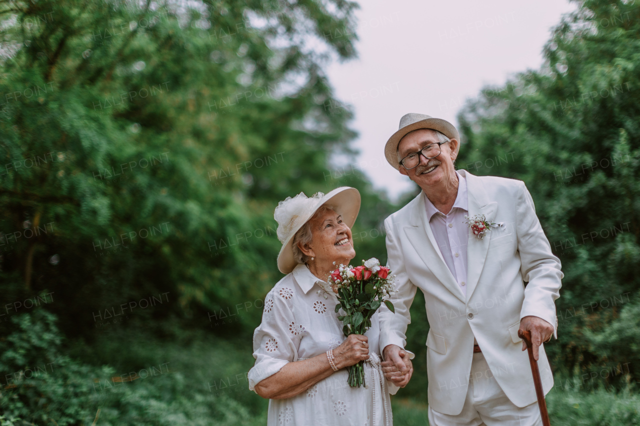 Senior couple having marriage in nature during a summer day.