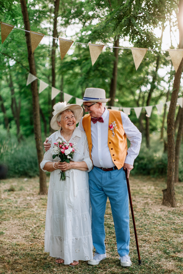 Senior couple having marriage in nature during a summer day.