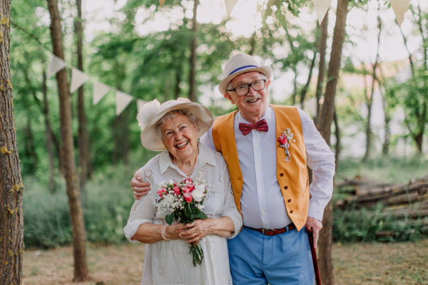 Senior couple having marriage in nature during a summer day.