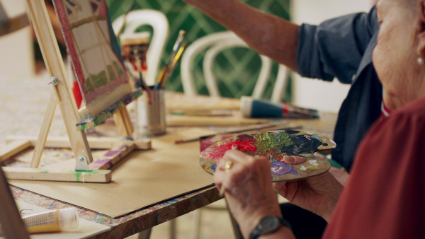 Senior couple painting together in an artist atelier.