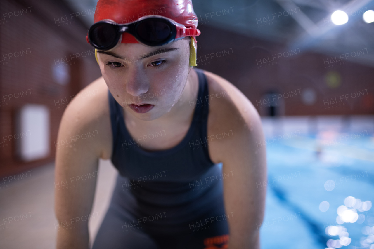 A young female swimmer with Down syndrome in swimming pool