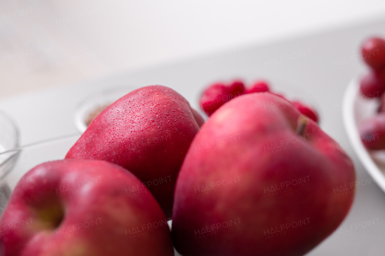 Fresh apples in a glass bowl on kitchen counter, healthy food for diet.