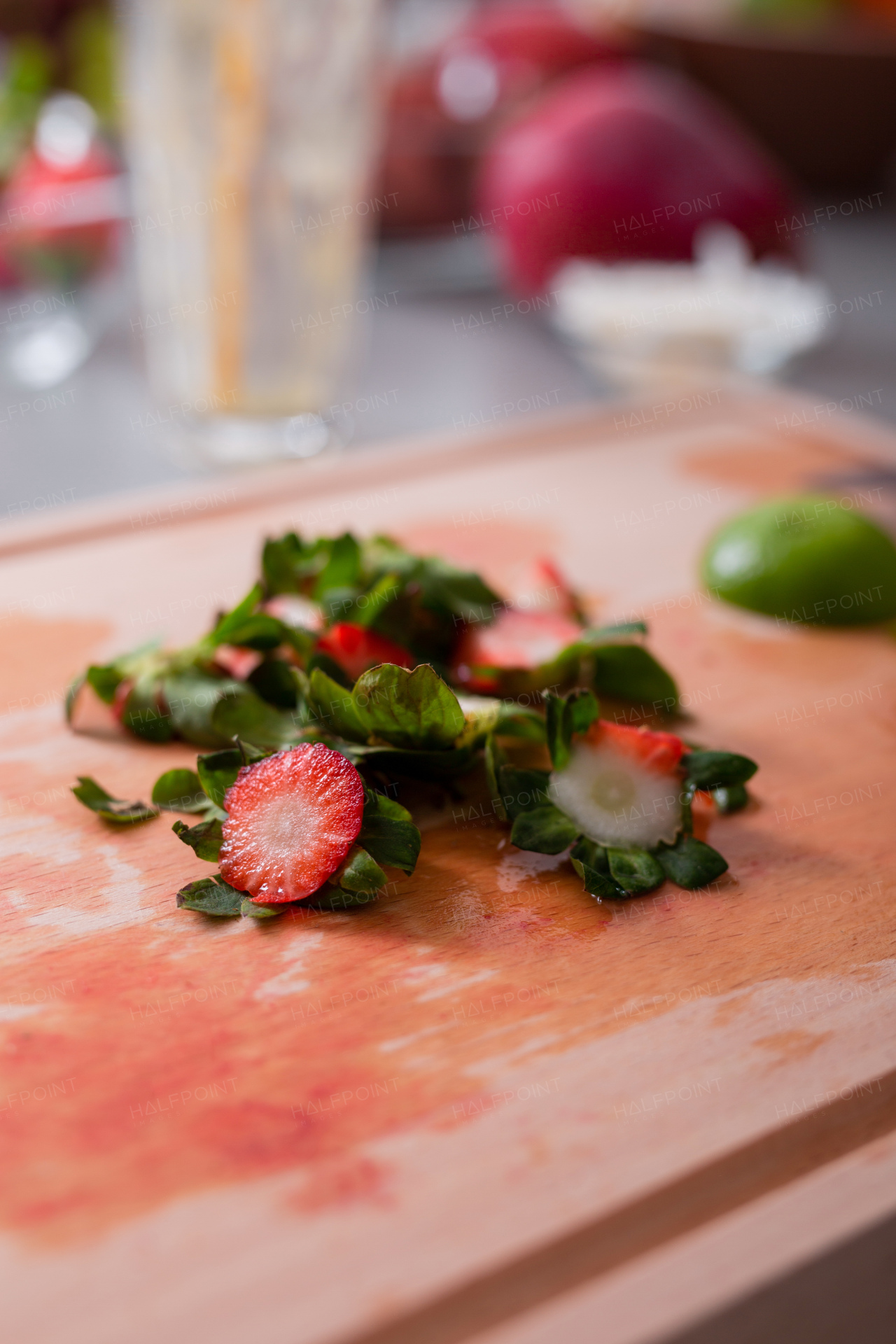 Strawberries cuttings on a chopping board in kitchen, healthy lifestyle concept.