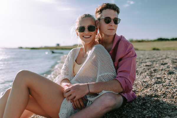 Young couple spending time at lake, enjoying summer.