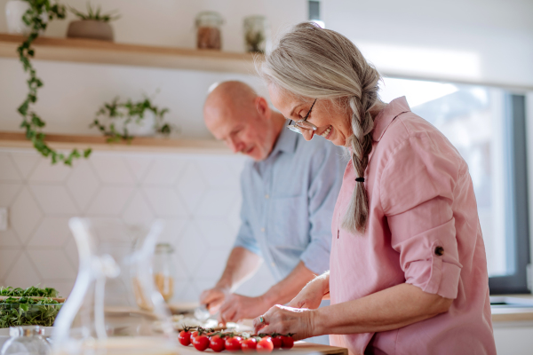 A senior couple cooking together at home.