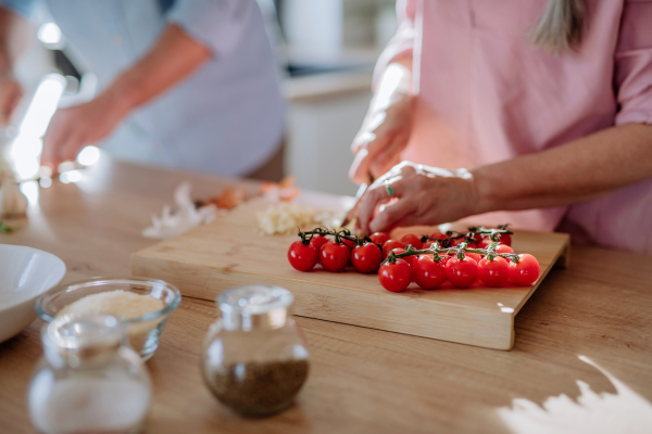 A senior couple cooking together at home.