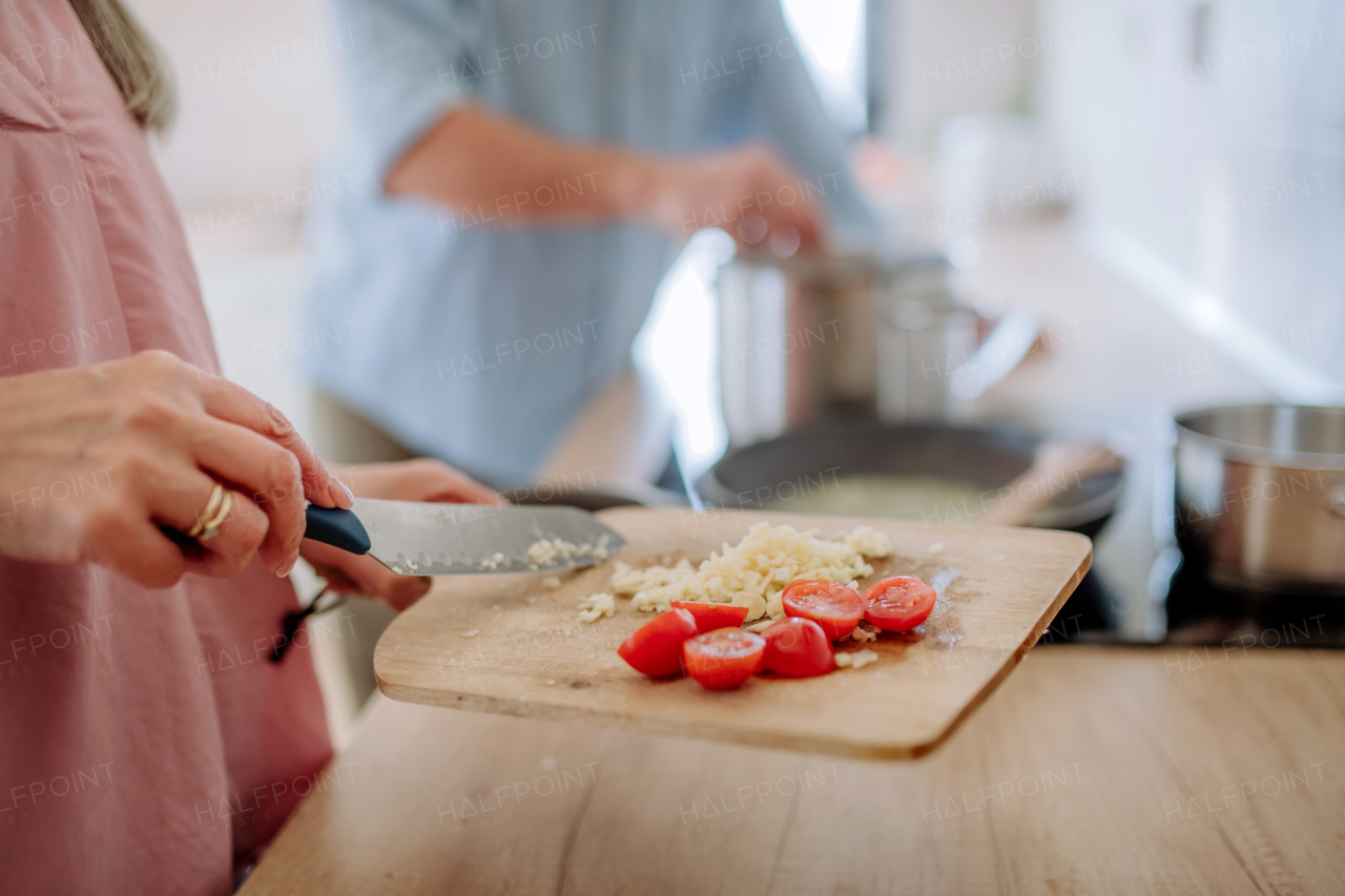 A senior couple cooking together at home.