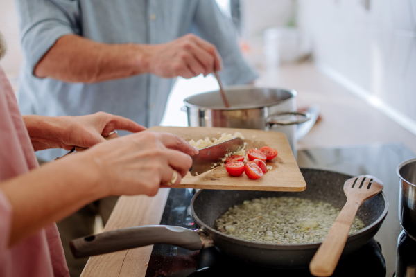 A senior couple cooking together at home.