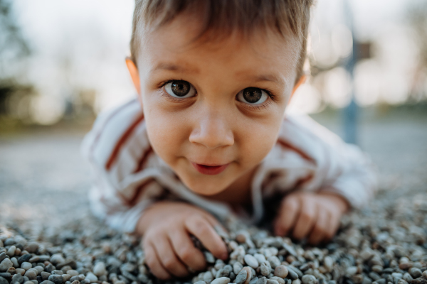 A little boy playing on an outdoor playground.