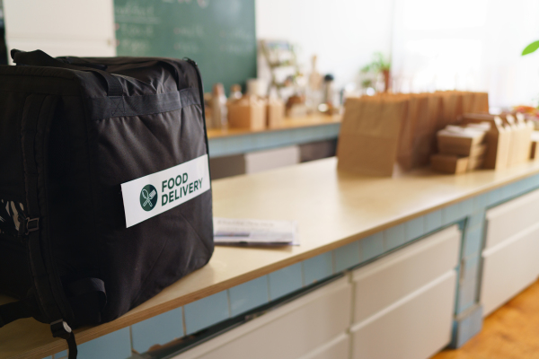 Take away boxes with lunch prepared for a delivery in thermo bag in restaurant.