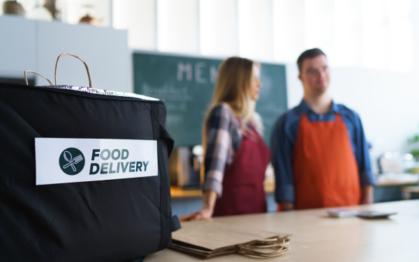 Take away boxes with lunch prepared for a delivery in thermo bag in restaurant.