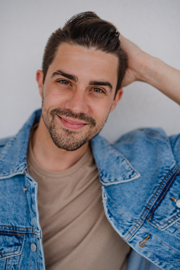 Portrait of a young caucasian man on white background, looking at camera.