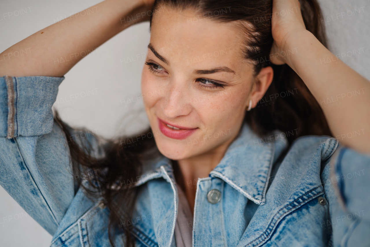 A close up of happy young caucasian woman on white background, smiling.