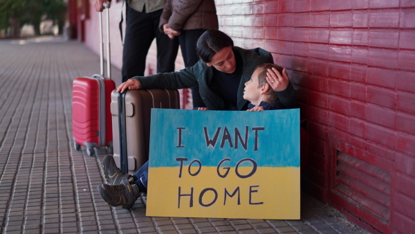 An Ukrainian refugee family in station waiting to leave Ukraine due to the Russian invasion of Ukraine.