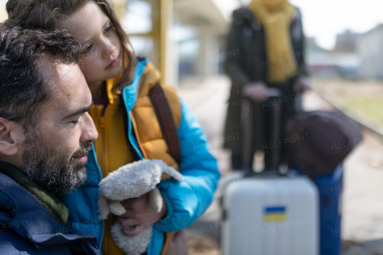 A close-up of Ukrainian girl hugging her father and saying goodbye before leaving, Ukrainian war concept.