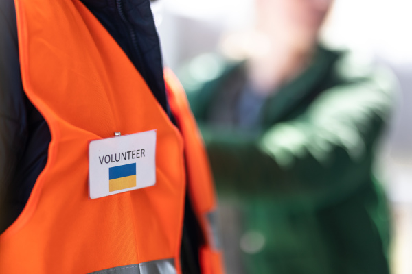 A volunteer registring Ukrainian refugees at train station.