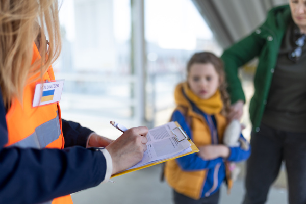 A volunteer registring Ukrainian refugees at train station.