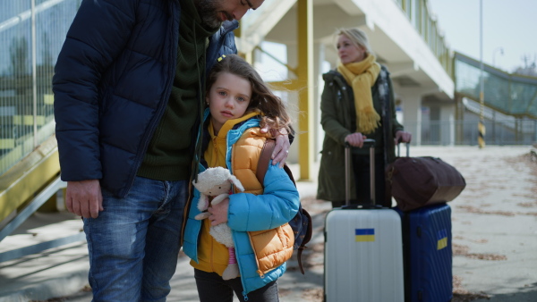 A close-up of Ukrainian girl hugging her father and saying goodbye before leaving, Ukrainian war concept.