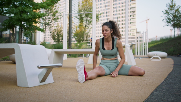 Happy man and woman couple friends doing workout exercise outdoors in city, talking.