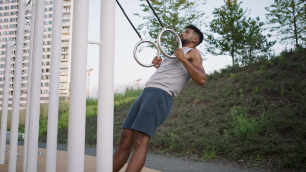 A young man doing exercise outdoors in city, healthy lifestyle concept.