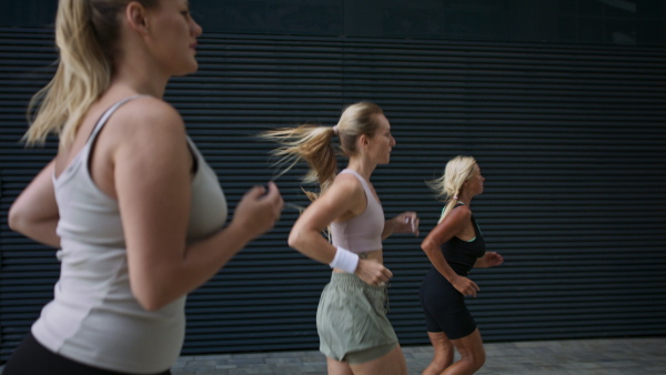 A group of young and old women running outdoors in city, healthy lifestyle concept.