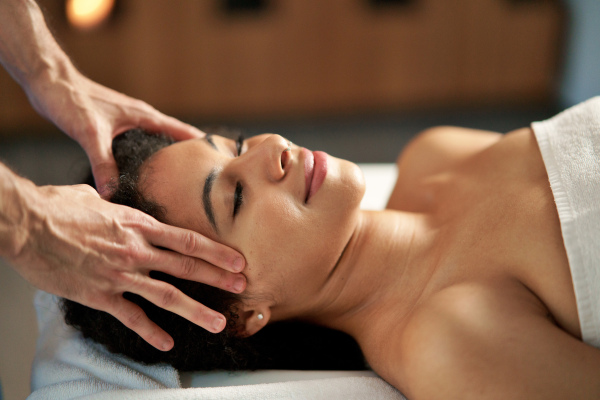 Young woman having relaxing head massage at the spa.