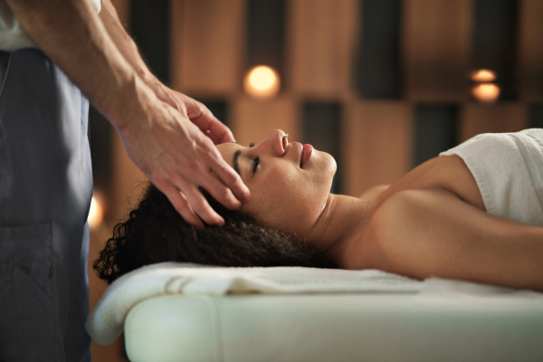 Young woman having relaxing head massage at the spa.