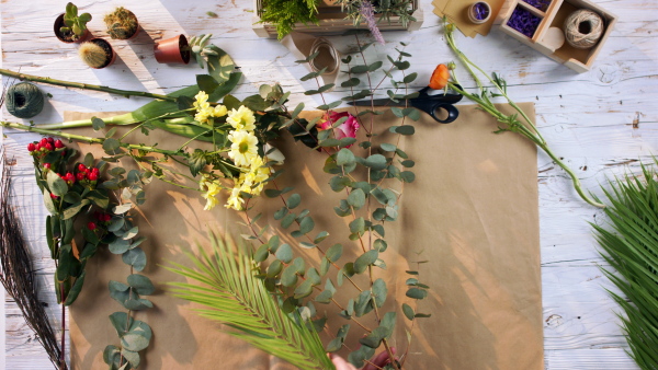 A top view woman making a bouquet.