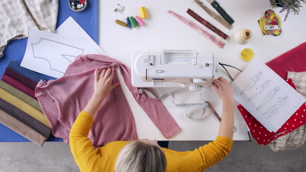 A top view of woman making clothes, coronavirus desktop concept.