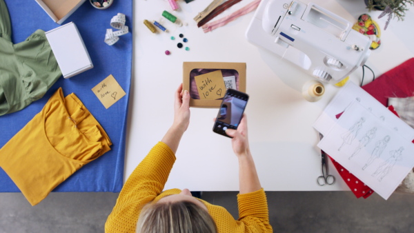 A top view of woman photographing package, coronavirus desktop concept.