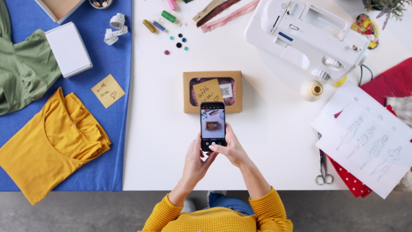 A top view of woman photographing package, coronavirus desktop concept.